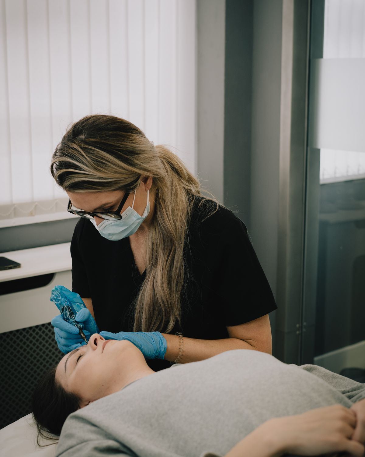 Mary Spence at work, creating brows on a client
